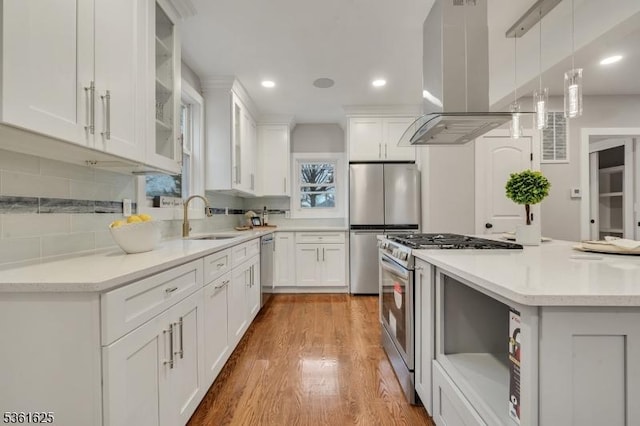 139 Weaver Ave, Bloomfield Twp, NJ 07003 - kitchen featuring island exhaust hood, a sink, stainless steel appliances, white cabinetry, and light wood-style floors