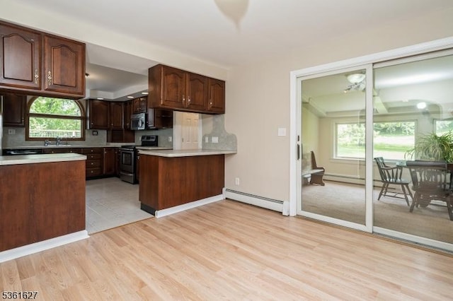 90 Libertyville Rd, Wantage Twp, NJ 07461 - kitchen with baseboard heating, appliances with stainless steel finishes, a sink, and light wood-style flooring