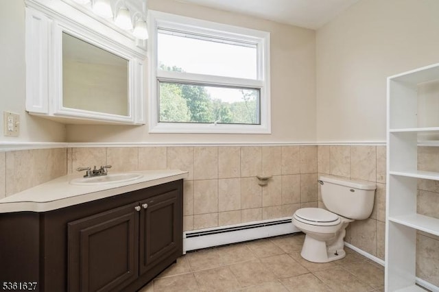 90 Libertyville Rd, Wantage Twp, NJ 07461 - bathroom featuring a baseboard heating unit, toilet, vanity, tile patterned floors, and wainscoting