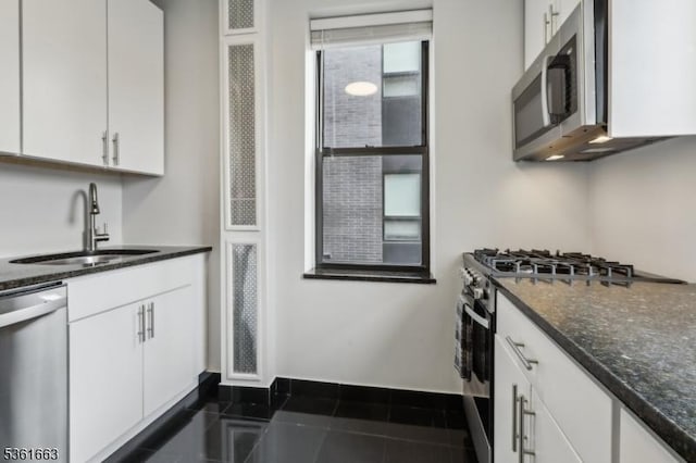 3315 Pleasant Ave Unit 314, Union City, NJ 07087 - kitchen featuring a sink, stainless steel appliances, white cabinetry, dark stone countertops, and baseboards