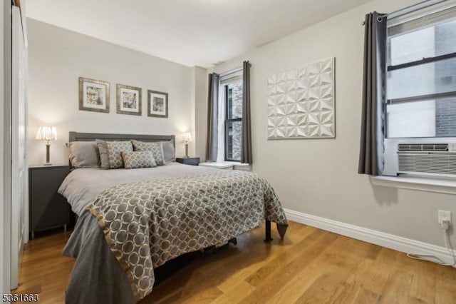 3315 Pleasant Ave Unit 314, Union City, NJ 07087 - bedroom with multiple windows, baseboards, wood finished floors, and cooling unit