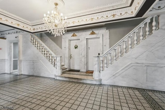 3315 Pleasant Ave Unit 314, Union City, NJ 07087 - entrance foyer featuring stairs, a chandelier, ornamental molding, wainscoting, and a decorative wall