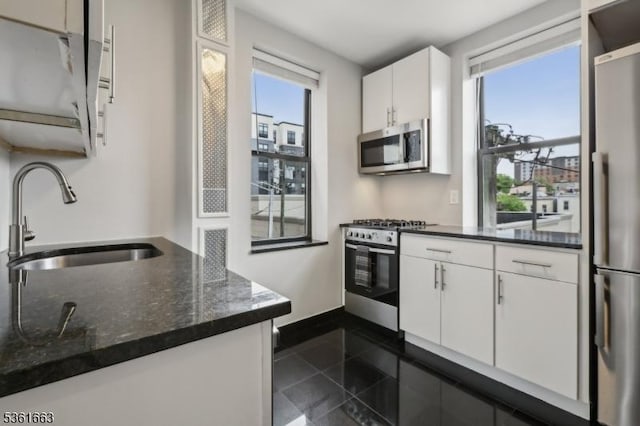3315 Pleasant Ave Unit 314, Union City, NJ 07087 - kitchen with appliances with stainless steel finishes, a sink, granite floors, white cabinets, and dark stone countertops