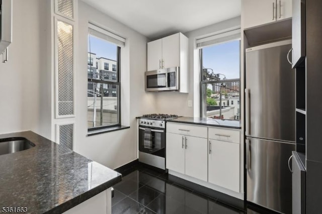 3315 Pleasant Ave Unit 314, Union City, NJ 07087 - kitchen with appliances with stainless steel finishes, granite tiled floors, white cabinetry, and healthy amount of natural light