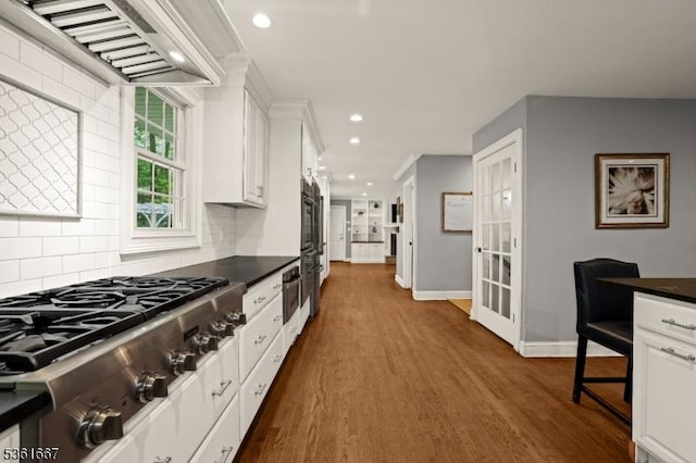 16 Old Chimney Rd, Randolph Twp, NJ 07869 - kitchen featuring stainless steel gas stovetop, wall chimney range hood, dark countertops, backsplash, and dark wood-style flooring