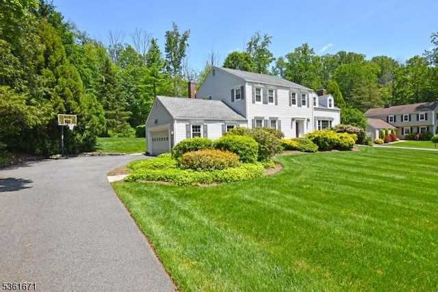 23 Pepperidge Rd, Morris Twp, NJ 07960 - colonial-style house featuring a front lawn, driveway, a garage, and a chimney