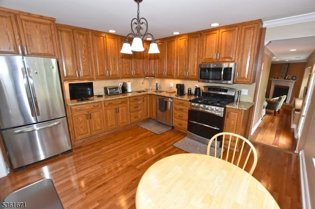 23 Pepperidge Rd, Morris Twp, NJ 07960 - kitchen featuring appliances with stainless steel finishes, a sink, brown cabinets, light wood-type flooring, and recessed lighting