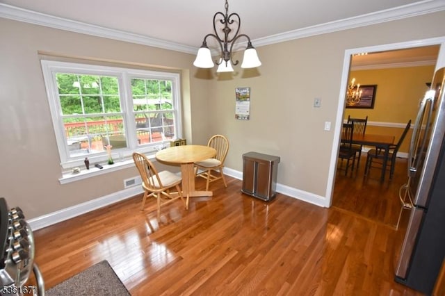 23 Pepperidge Rd, Morris Twp, NJ 07960 - dining space with a chandelier, baseboards, ornamental molding, and wood finished floors