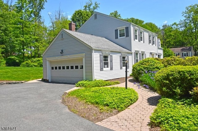 23 Pepperidge Rd, Morris Twp, NJ 07960 - view of front facade with a garage, driveway, a chimney, and a shingled roof