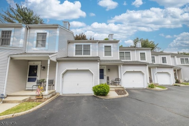17 Iron Forge Vlg S, Pompton Lakes Boro, NJ 07442 - townhome / multi-family property featuring a chimney, driveway, and an attached garage