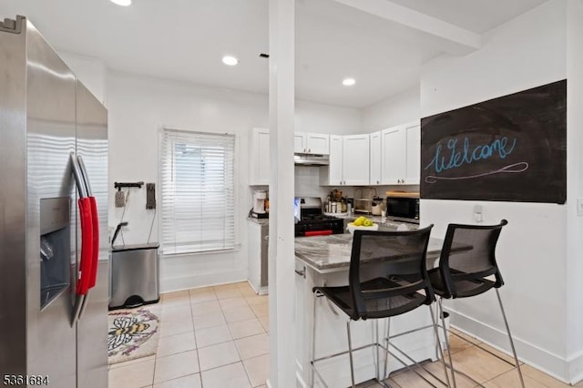 46 Harmony St, North Plainfield Boro, NJ 07060 - kitchen featuring appliances with stainless steel finishes, under cabinet range hood, light tile patterned floors, white cabinetry, and recessed lighting