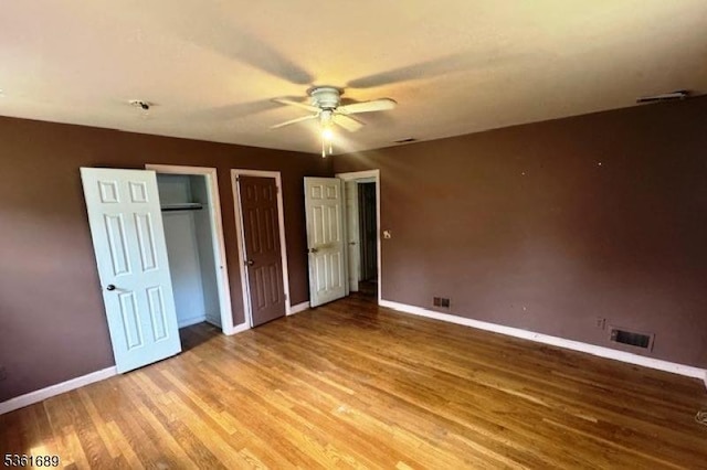 17 Hilltop Cir, Hanover Twp, NJ 07981 - unfurnished bedroom featuring multiple closets, baseboards, light wood-style flooring, and a ceiling fan