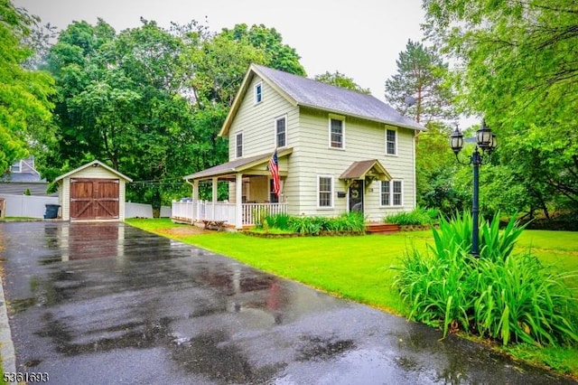 328 John St, Bound Brook Boro, NJ 08805 - view of front of house with a garage, a shed, covered porch, a front yard, and view of scattered trees