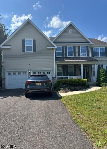 7 Westbury Dr, Winslow Twp, NJ 08009 - view of front of house with a garage, asphalt driveway, a porch, and a front lawn