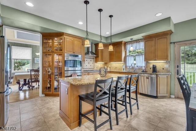 11 Wesley Rd, Hillsborough Twp, NJ 08844 - kitchen with appliances with stainless steel finishes, wall chimney range hood, a sink, light stone counters, and backsplash