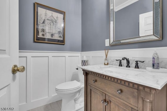 11 Wesley Rd, Hillsborough Twp, NJ 08844 - bathroom with vanity, wainscoting, toilet, a decorative wall, and tile patterned floors