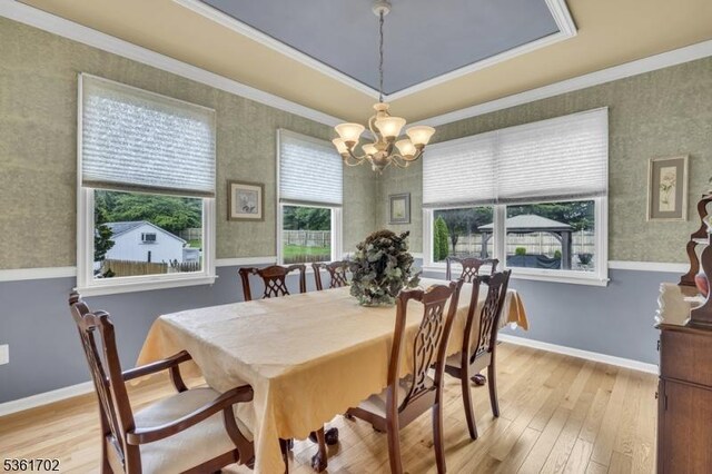 11 Wesley Rd, Hillsborough Twp, NJ 08844 - dining space featuring a chandelier, light wood-style floors, wallpapered walls, ornamental molding, and a tray ceiling