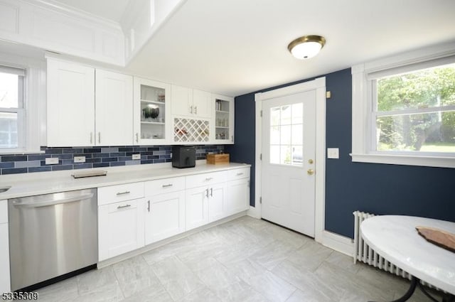 7 Clinton St, Morristown Town, NJ 07960 - kitchen featuring stainless steel dishwasher, light countertops, baseboards, glass insert cabinets, and decorative backsplash