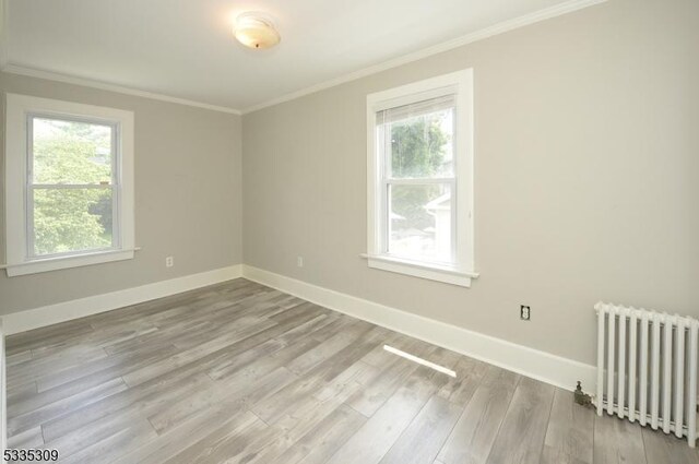 7 Clinton St, Morristown Town, NJ 07960 - spare room featuring radiator, ornamental molding, plenty of natural light, wood finished floors, and baseboards