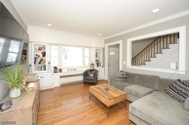 7 Clinton St, Morristown Town, NJ 07960 - living area with radiator, ornamental molding, light wood finished floors, built in shelves, and stairway