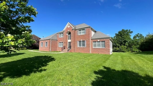 2 Murphy Dr, Hillsborough Twp, NJ 08844 - back of property featuring brick siding and a yard