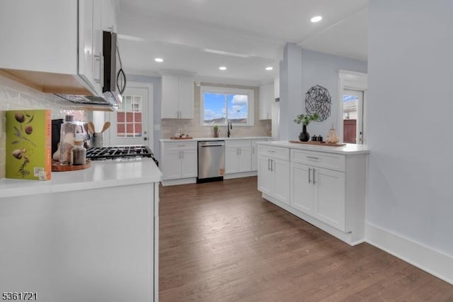 234 Trenton Ave, Clifton City, NJ 07011 - kitchen featuring stainless steel appliances, decorative backsplash, wood finished floors, white cabinetry, and recessed lighting