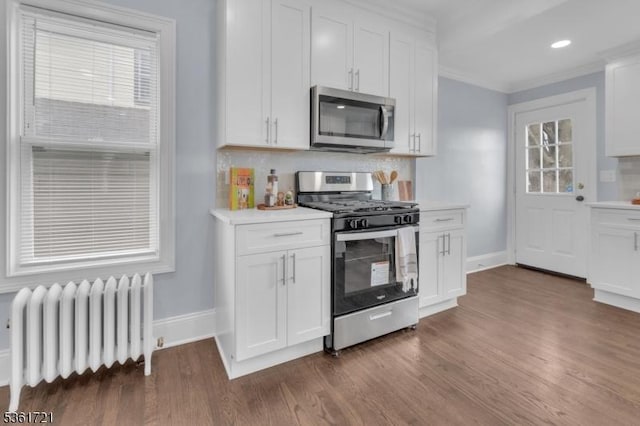 234 Trenton Ave, Clifton City, NJ 07011 - kitchen with stainless steel appliances, radiator, baseboards, dark wood-type flooring, and ornamental molding