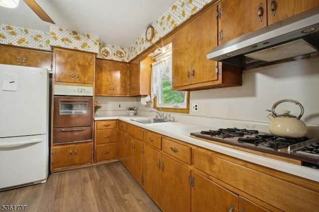 28 Stylon Rd, Wayne Twp, NJ 07470 - kitchen with white appliances, under cabinet range hood, a warming drawer, wood finished floors, and brown cabinets