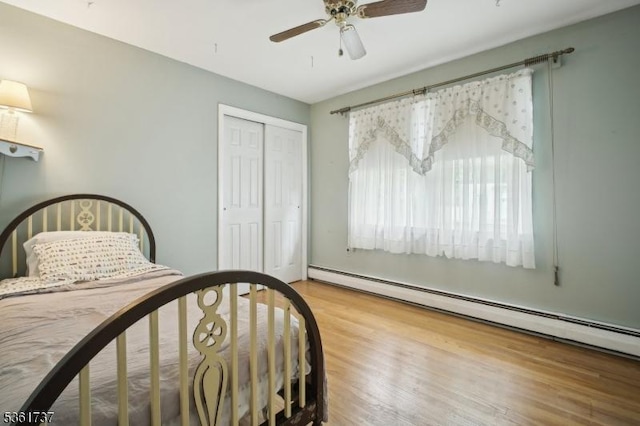 28 Stylon Rd, Wayne Twp, NJ 07470 - bedroom with a baseboard heating unit, a closet, wood finished floors, and a ceiling fan