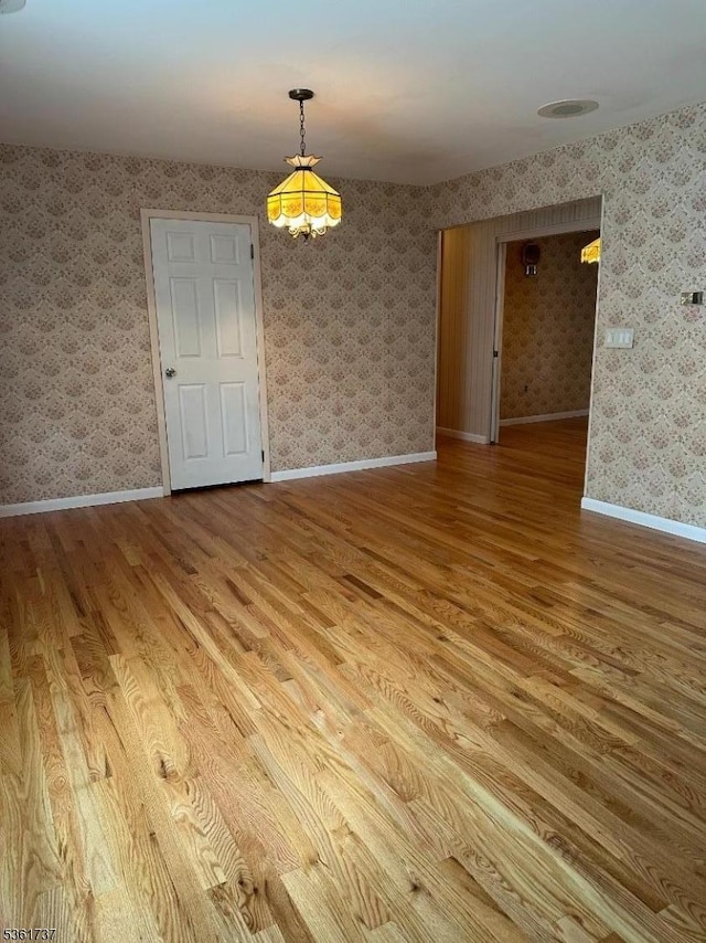 28 Stylon Rd, Wayne Twp, NJ 07470 - spare room featuring wood finished floors, wallpapered walls, and a chandelier