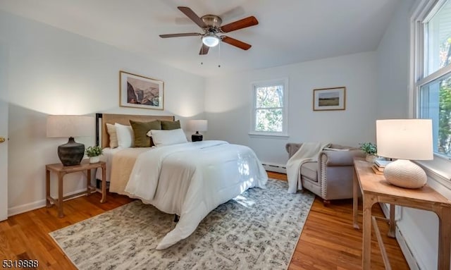 1473 Sussex Tpke, Randolph Twp, NJ 07869 - bedroom with light wood-type flooring, a baseboard radiator, ceiling fan, and baseboards