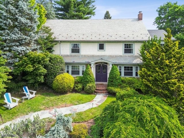 27 Fairway Dr, West Orange Twp, NJ 07052 - view of front facade with a chimney, a high end roof, and a front lawn