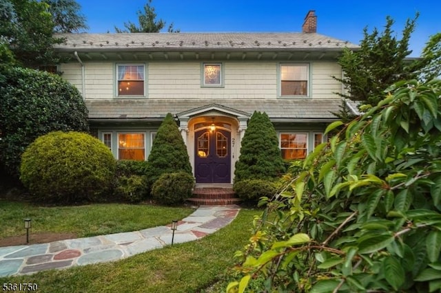 27 Fairway Dr, West Orange Twp, NJ 07052 - view of front of house with a chimney and a front lawn