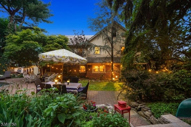 27 Fairway Dr, West Orange Twp, NJ 07052 - back of property featuring a patio, brick siding, and a fire pit