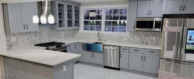 101 Van Buren St, Woodbridge Twp, NJ 07095 - kitchen featuring appliances with stainless steel finishes, gray cabinetry, a sink, light stone countertops, and backsplash