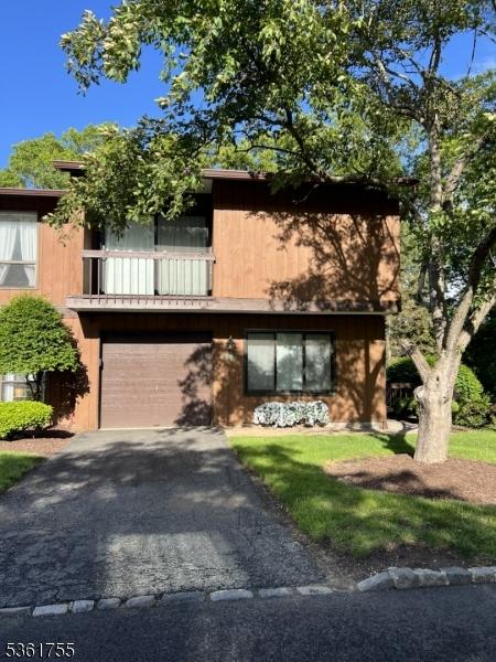 1070 Treetops, Wharton Boro, NJ 07885 - view of front of property featuring driveway, an attached garage, and a balcony