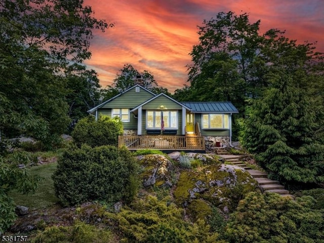 172 Alpine Trl, Sparta Twp, NJ 07871 - back of property at dusk with a porch and a standing seam roof