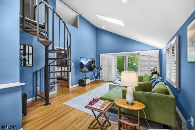 172 Alpine Trl, Sparta Twp, NJ 07871 - living room with a skylight, stairway, a baseboard heating unit, wood finished floors, and baseboards