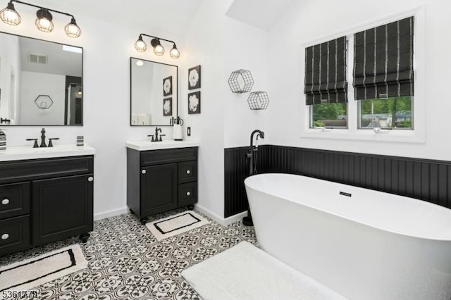 11 Putnam Ave, Berkeley Heights Twp, NJ 07922 - full bath featuring two vanities, a freestanding bath, vaulted ceiling, and baseboards