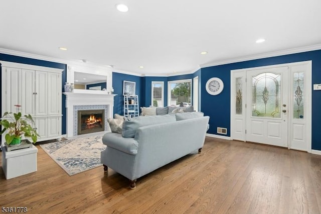 11 Putnam Ave, Berkeley Heights Twp, NJ 07922 - living room featuring wood finished floors, recessed lighting, a tiled fireplace, crown molding, and baseboards