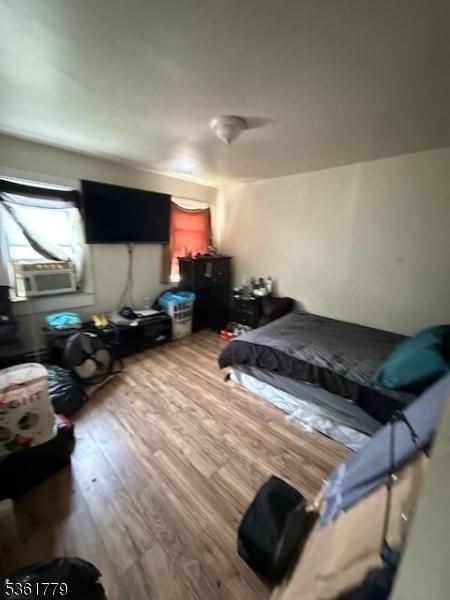 286 N 6th St, Prospect Park Boro, NJ 07508 - bedroom with wood finished floors and cooling unit