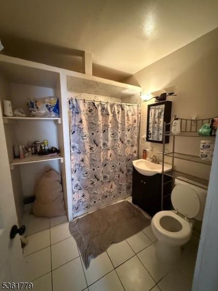 286 N 6th St, Prospect Park Boro, NJ 07508 - full bathroom with vanity, toilet, tile patterned floors, and a shower with curtain