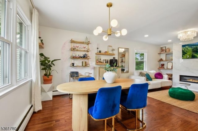 121 3rd St, South Orange Village Twp, NJ 07079 - dining space featuring a chandelier, a baseboard heating unit, dark wood finished floors, and a premium fireplace