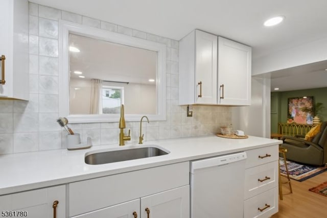 121 3rd St, South Orange Village Twp, NJ 07079 - kitchen with white dishwasher, a sink, white cabinets, and tasteful backsplash