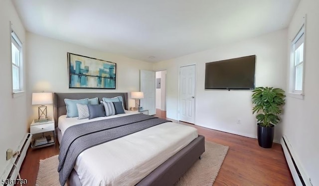 121 3rd St, South Orange Village Twp, NJ 07079 - bedroom with a baseboard heating unit, wood finished floors, and baseboards