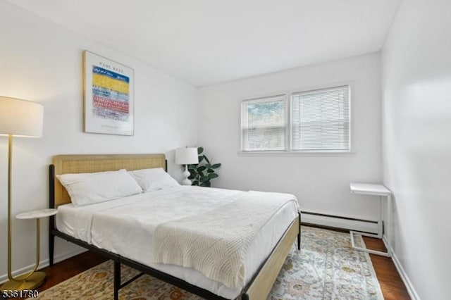 121 3rd St, South Orange Village Twp, NJ 07079 - bedroom featuring a baseboard heating unit, wood finished floors, and baseboards