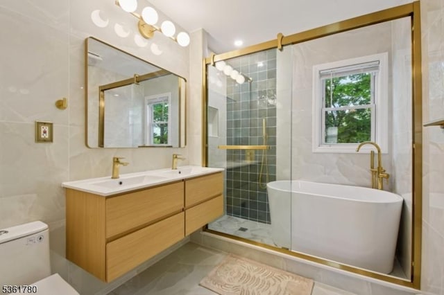 121 3rd St, South Orange Village Twp, NJ 07079 - bathroom featuring tile walls, a soaking tub, double vanity, a stall shower, and tile patterned flooring