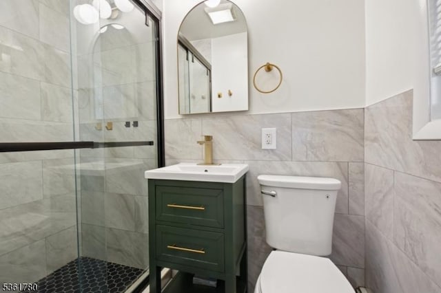 121 3rd St, South Orange Village Twp, NJ 07079 - bathroom featuring toilet, vanity, a shower stall, and tile walls