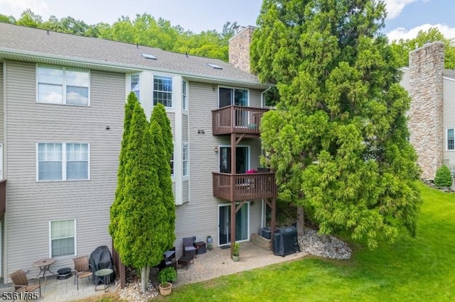 20 Pinehurst Dr, Washington Twp, NJ 07882 - back of house with a patio, a chimney, a lawn, and a balcony