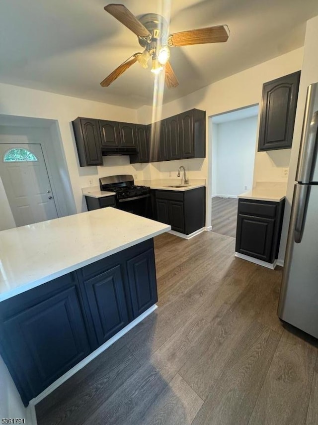 637 Union St, City Of Orange Twp, NJ 07050 - kitchen featuring gas range, freestanding refrigerator, dark wood-style floors, under cabinet range hood, and light countertops